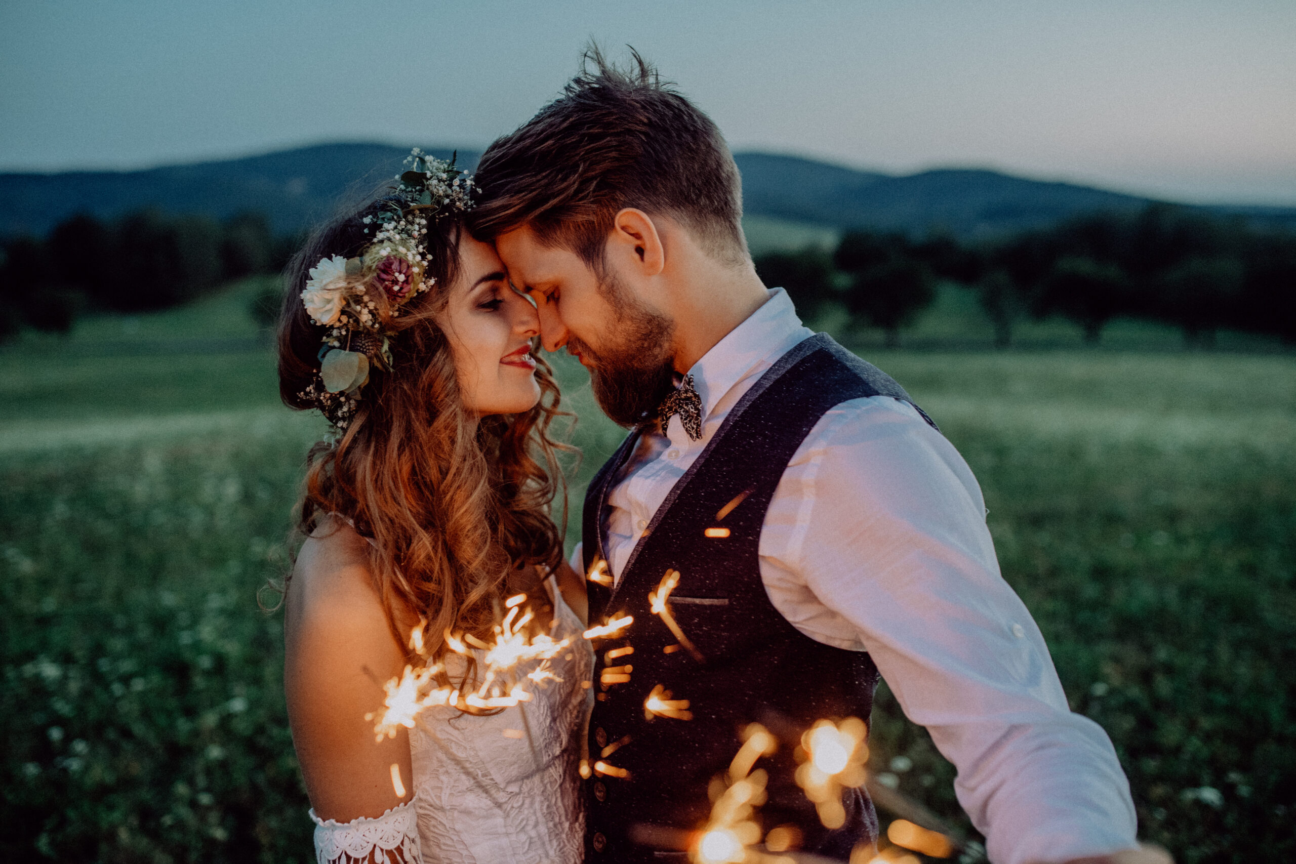 Beautiful,Bride,And,Groom,With,Sparklers,On,A,Meadow. Twilight wedding