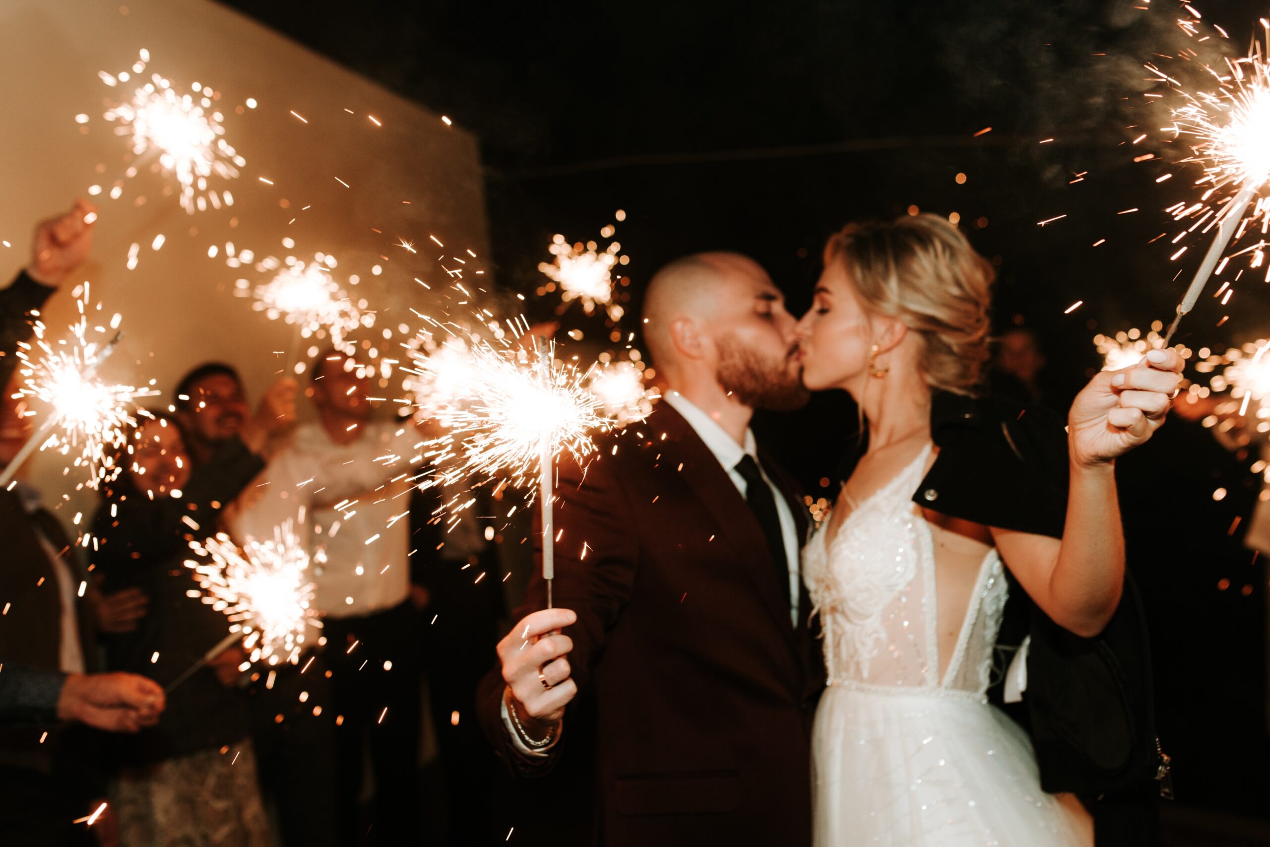 At,The,Wedding,,The,Bride,And,Groom,Hold,Sparklers,In
